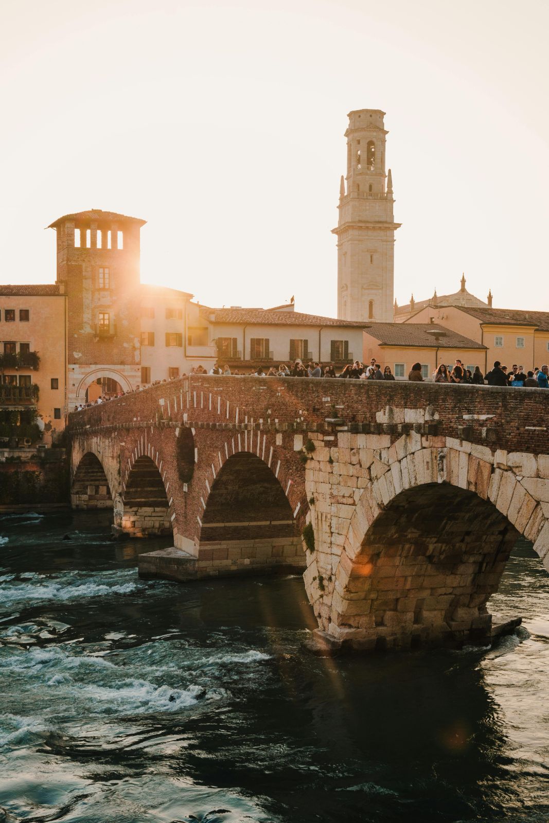 Ponte Pietra, the Roman stone bridge over the Adige river in Verona, glowing at sunset